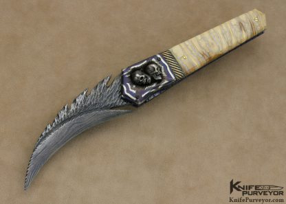 Arthur Whale Custom Knife Blued Carved Damascus with Damascus Bolsters with Silver Skulls and Mammoth Tooth Linerlock